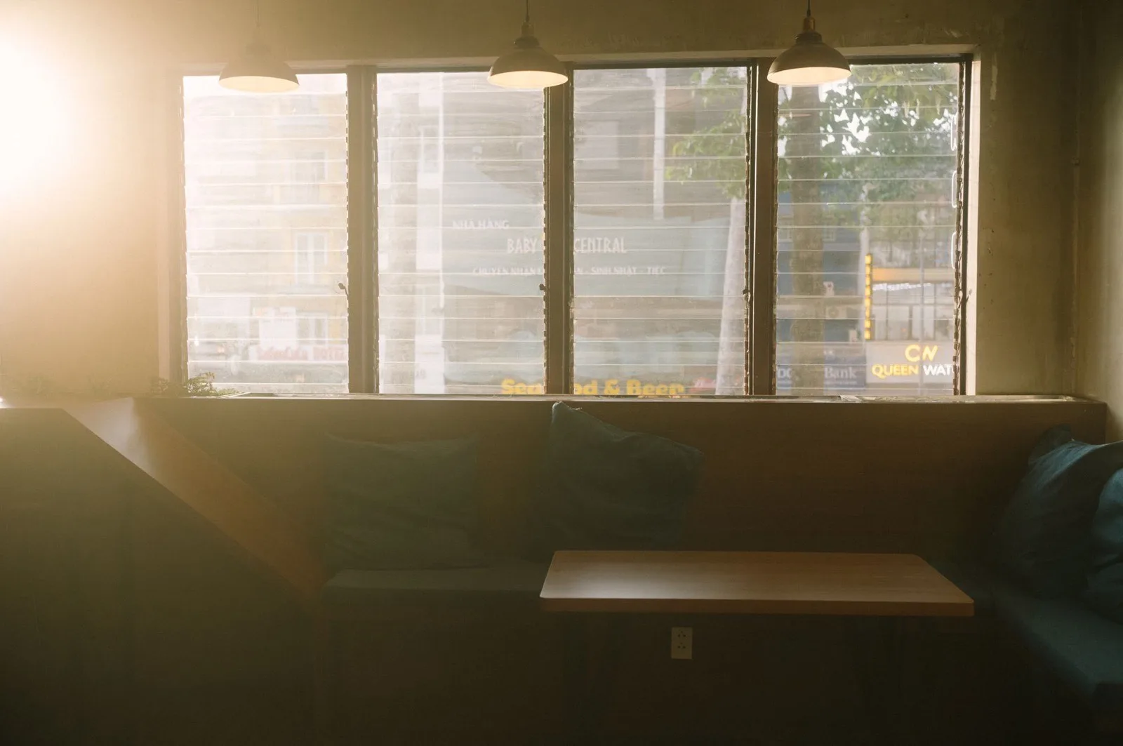 An empty café booth in the late afternoon, backlit by a window.